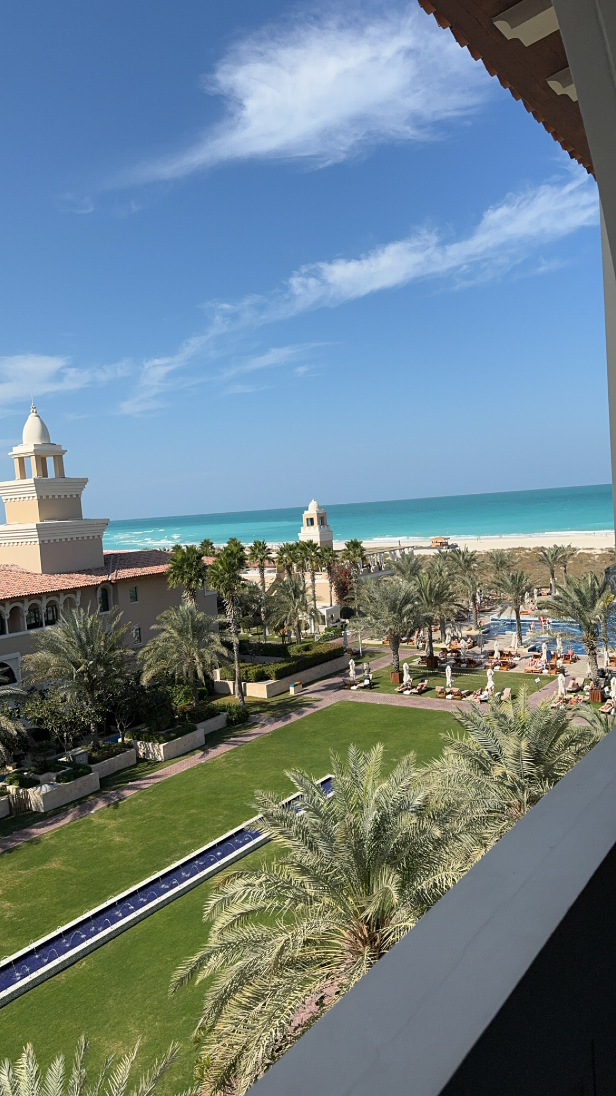 View over the resort gardens and fountains toward the turquoise sea