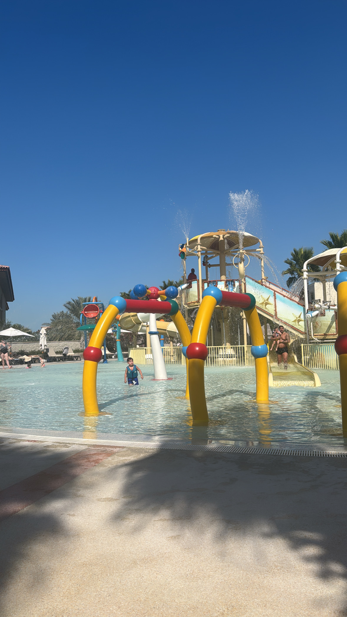 Children playing in the colourful splash park